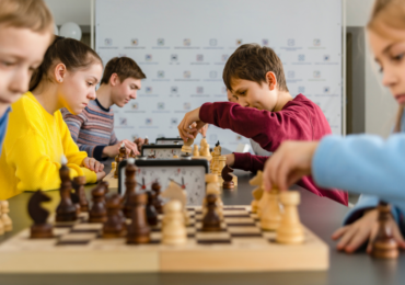 children at holiday club playing chess