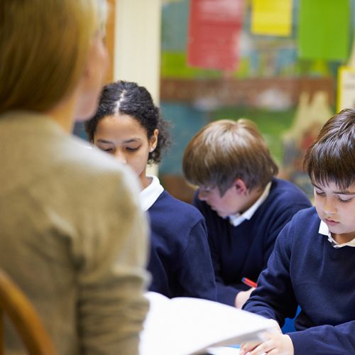 school children in a classroom receiving a lesson on allegies